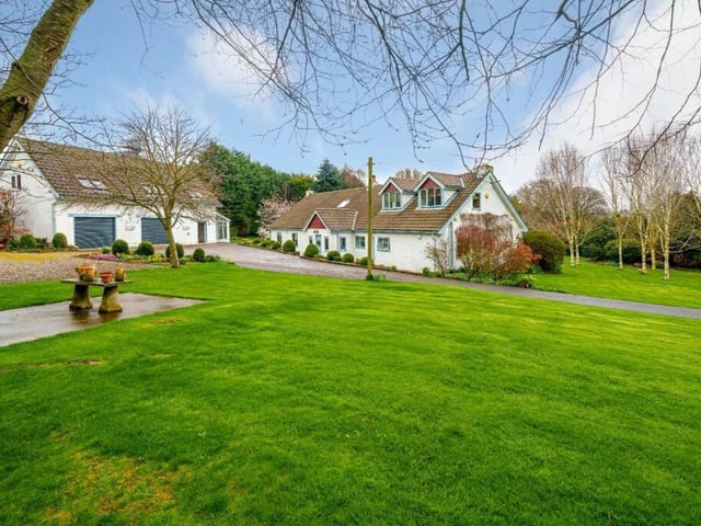 The approach to the four-bedroom property with detached double garage.