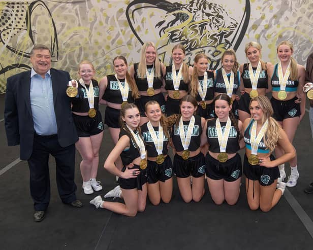 Cllr Eric Broadbent, left, and Cllr Tony Randerson, right, with the World Champion cheerleaders from the East Coast Tigers team.
