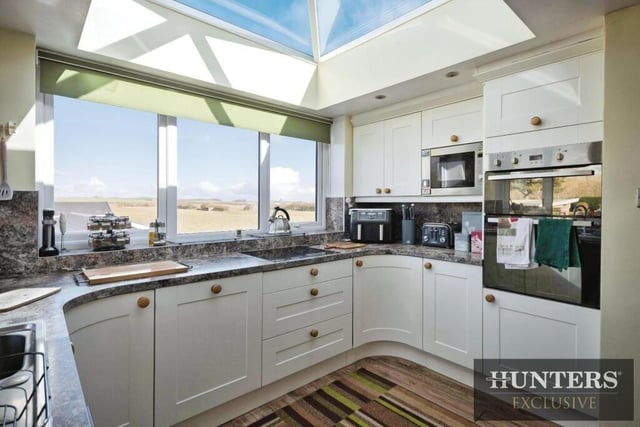 The modern kitchen has a lantern style roof admitting plenty of natural light.
