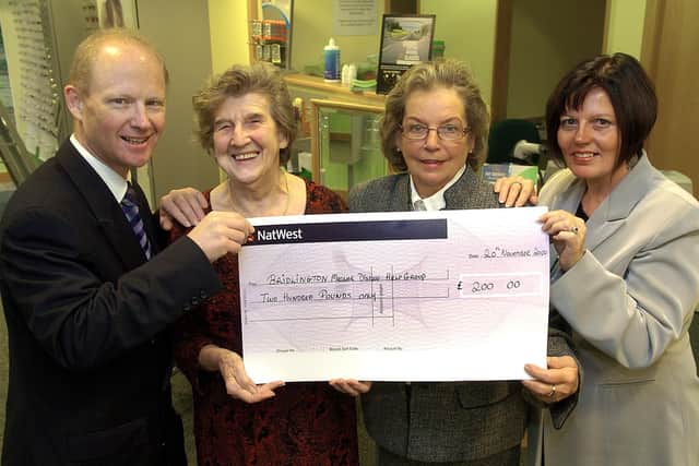 Specsavers presents a cheque to the Bridlington Macular Disease Help Group in 2007.