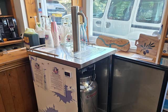 The milk still arrives a t the shop in a churn and reusable bottles are available to purchase at every Udderly Dale-icious site.