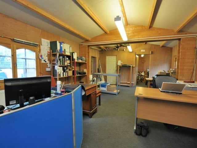 A large log cabin is part of the property, and makes an ideal home office or workshop.