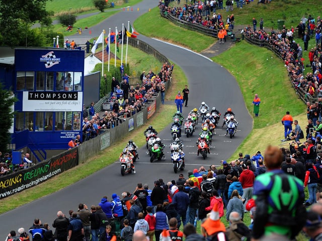 Motor cycle road racers speed off the start line for the Steve Henshaw Gold Cup race in 2012.