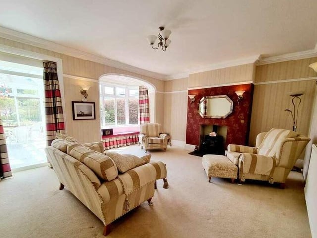 Features in this lounge include a decorative fireplace and a bay window with window seat.