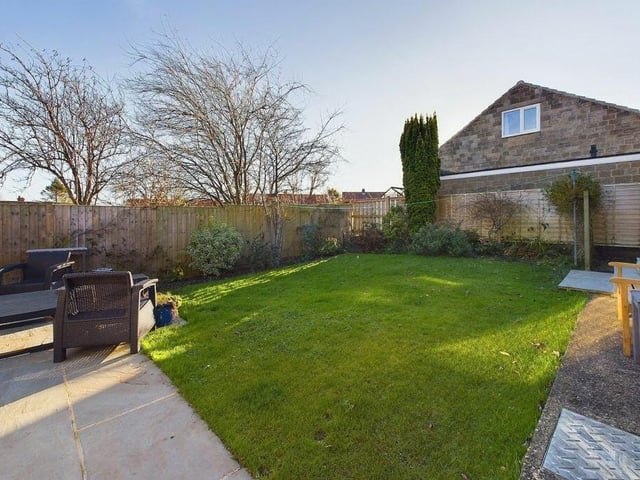 The rear garden, with lawn and patio.