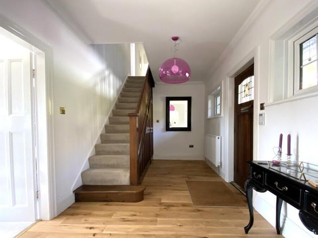 The hallway has under stairs storage.