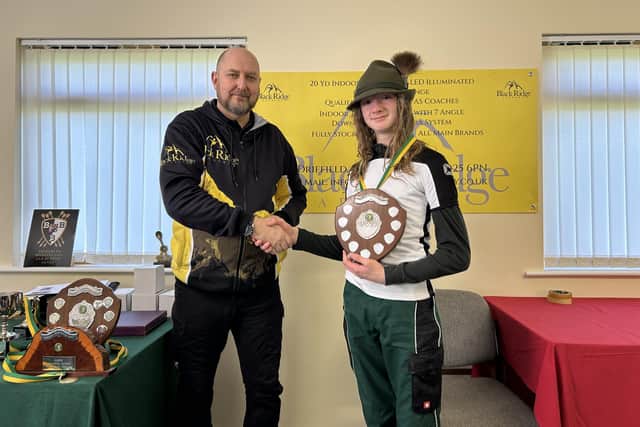 Junior Gent Longbow Champion Edward Chester (right) is presented with his trophy.