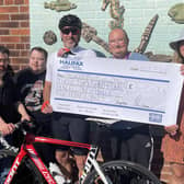 Cyclist Robert Wilson with the money he has raised for the Dalewood Trust in Whitby and GEMS.