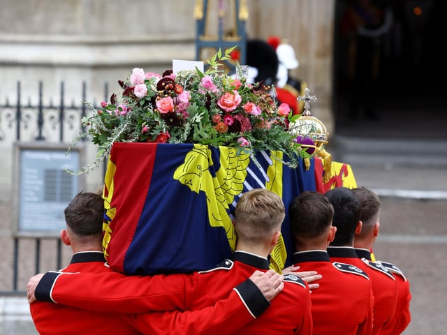 The coffin of Britain's Queen Elizabeth is carried into the Westminster Abbey during the state funeral and burial of Queen Elizabeth II at Westminster Abbey. (Photo by Hannah McKay- WPA Pool/Getty Images)