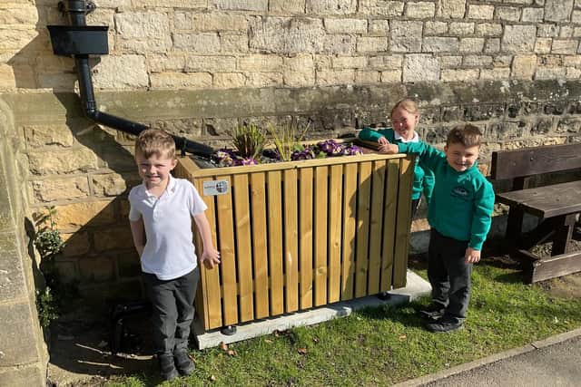 Pickering Infant School pupils pose next to the new SuDS planter.