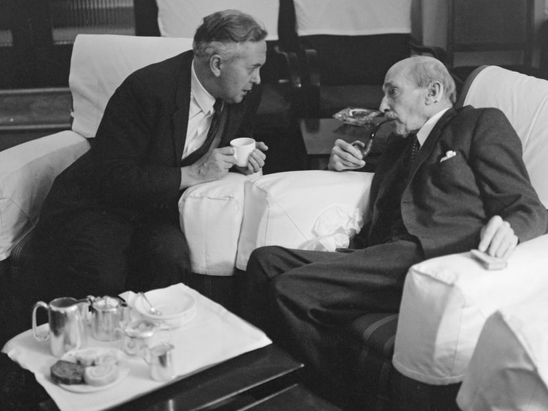 British Labour leader Harold Wilson (1916 - 1995, left) speaking to former Labour leader and Prime Minister Clement Attlee (1883 - 1967) at the Labour Party Conference in Scarborough, October 1963.