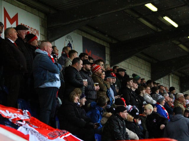 The travelling army of Scarborough Athletic fans cheer their team on at the Deva Stadium.