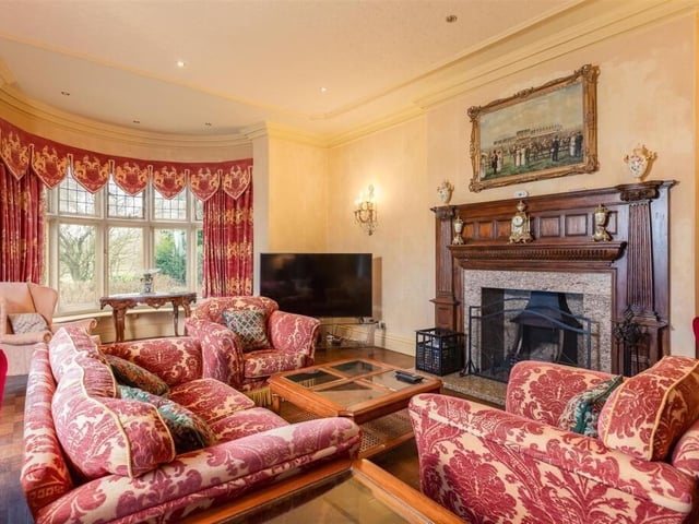 A reception room with feature fireplace.