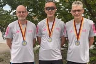 From left, Scarborough AC trio Dale Hepples, Pete Smith and David Field show off their medals after completing the 2025 Berlin Marathon in extremely humid conditions.