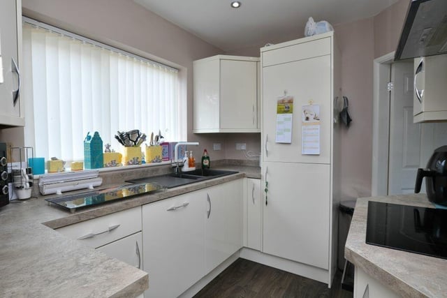 The modern kitchen has fitted units and integrated appliances.