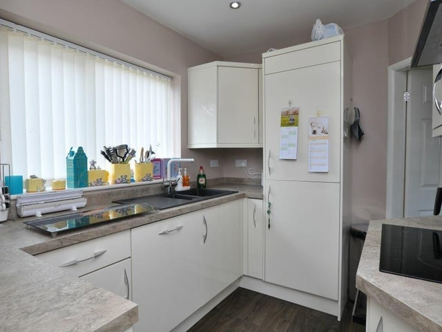 The modern kitchen has fitted units and integrated appliances.