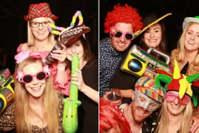 Party-goers at the Hog and Hoedown event enjoy the photo booth.