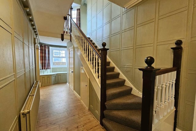 Panelled walls are a feature of the entrance hallway and staircase.