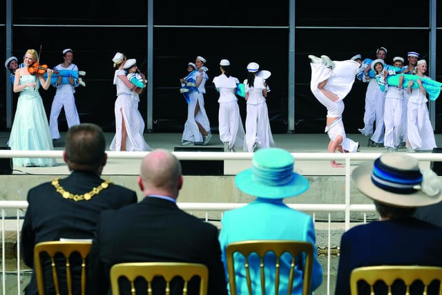Scarborough's talented youngsters perform for the Queen (blue hat) with violinist Victoria Yellop.
102087m