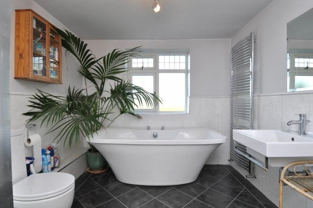 A stylish bathroom with free-standing bath as a feature.