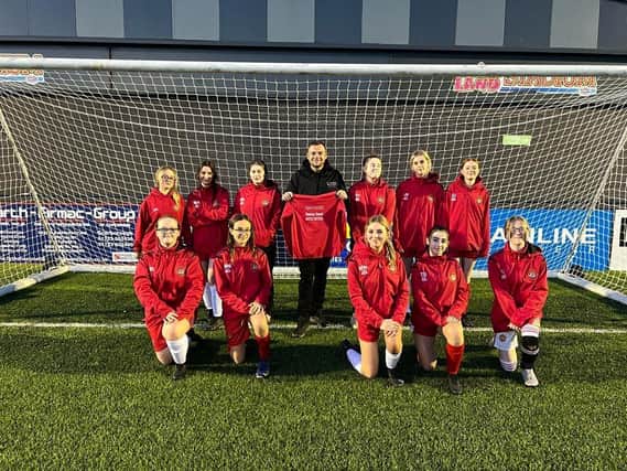 Scarborough Ladies FC Under-15s line up in their new training tops sponsored by Danny Dack - Travel Counsellor, with Dack handing over the new tops
