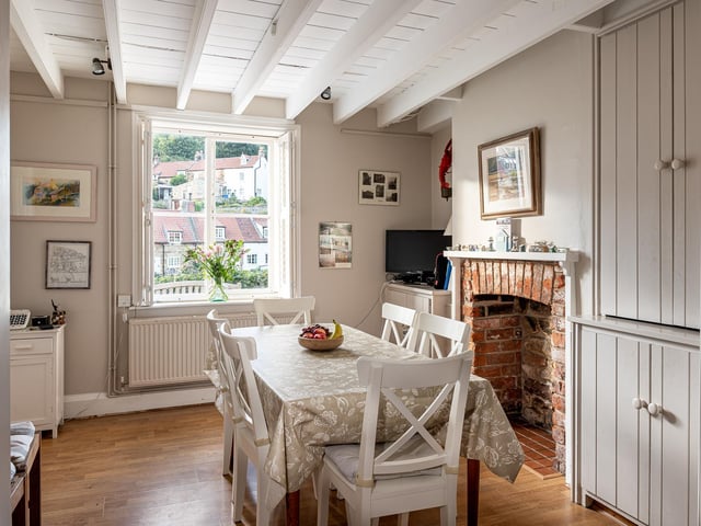 The dining area with brick fireplace feature.