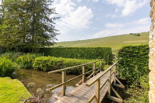A garden footbridge over Thornton Beck, to open countryside.