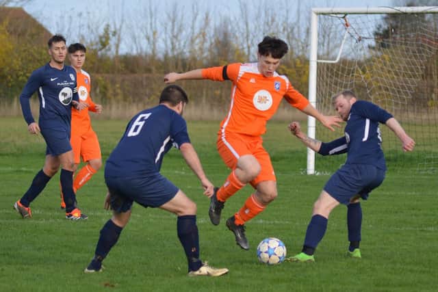 Action from Saturday’s Ryedale Hospital Cup clash between Heslerton (orange kit) Wombleton