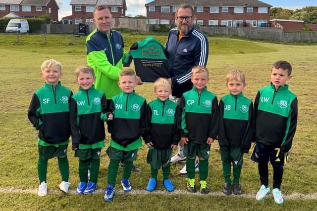 Eastfield Cars' Andy Thorpe, back, right, presents the sponsored tops to AFC Eastfield U6s coach Dave Leather, with the players lined up in front.