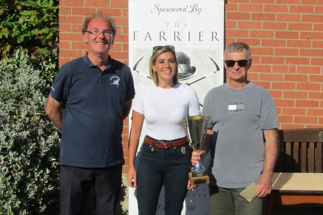 Winners Robert Child, left, and Ian Richardson collect the trophy from Danielle Bushby.from The Farrier.