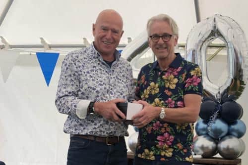 Jonathan Knight, left, recieving his 10-year award from Tim Lawson, right.