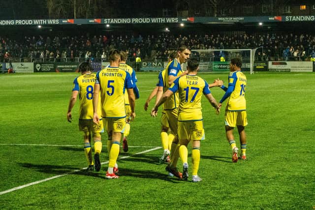 Boro forward Dom Tear, no 17, is congratulated for his leveller at Macclesfield. Photo by Chris Marson