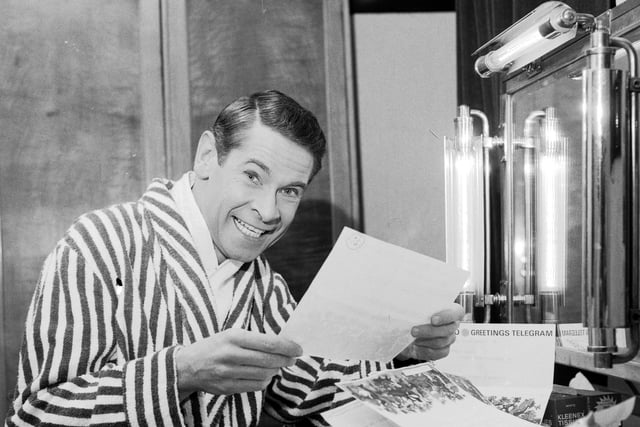 Scottish entertainer Stanley Baxter reads some of his telegrams in his dressing rooms backstage at the King's Theatre in April 1966.
