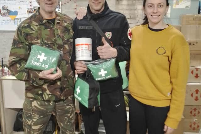 Michael Betoin (left) with some of the first aid supplies.