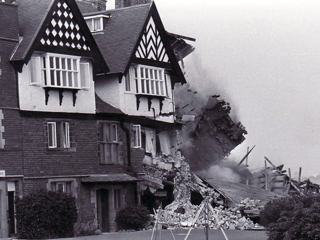 Brickwork falls to the floor as the hotel collapses.