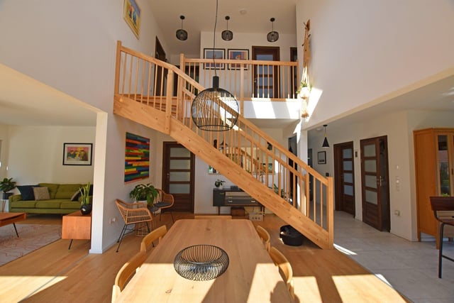 The open plan interior with feature staircase and gallery landing.