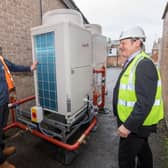 Cllr Greg White (right) discussing the new air source heat pump at Malton library with HCS contractor David Flowers.