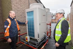 Cllr Greg White (right) discussing the new air source heat pump at Malton library with HCS contractor David Flowers.