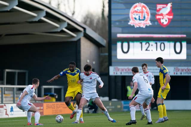 Kieran Weledji battles it out with Fylde. Photo by Wandering Photography