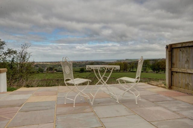 This patio seating area has glorious views over to the coast.