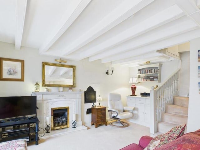 A central fireplace features in the living room.
