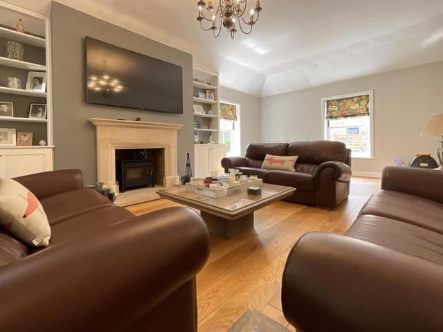 One of two spacious and double aspect sitting rooms, with a central feature fireplace.