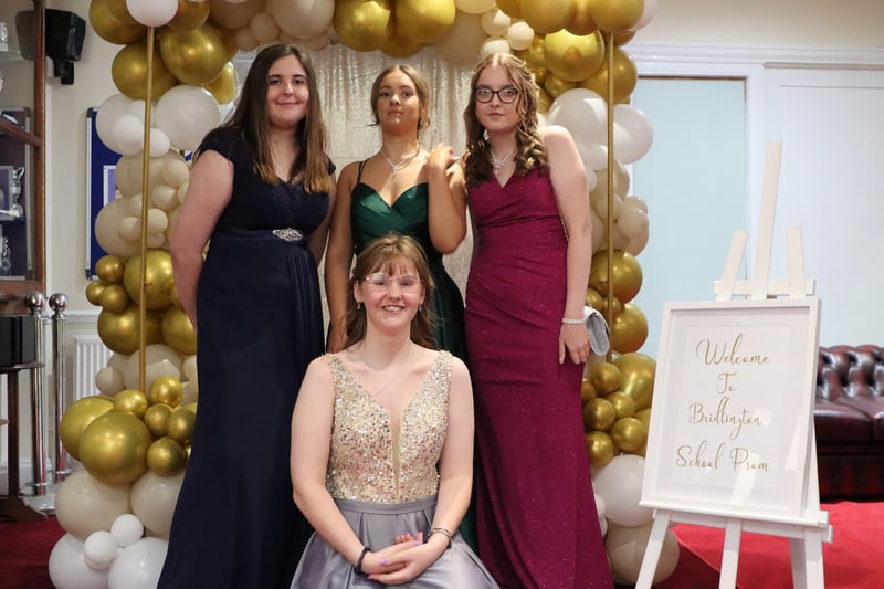 This group of friends are looking fantastic in front of the special balloon display.