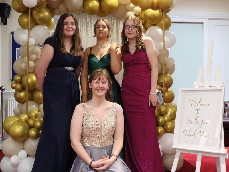 This group of friends are looking fantastic in front of the special balloon display.