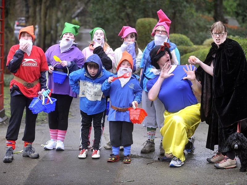 Fairytale walkers take a break to offer Snow White an apple