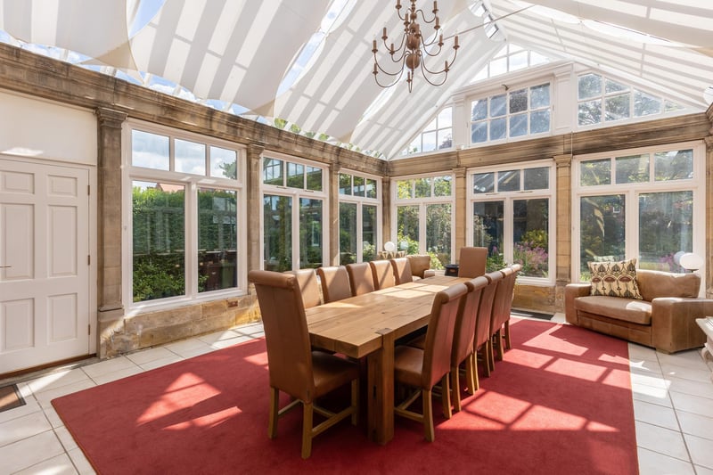The orangery is a large and versatile space with doors out to the garden.