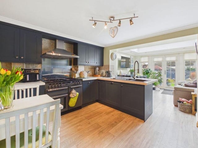 The modern, open plan breakfast kitchen links through to a sunny garden room.