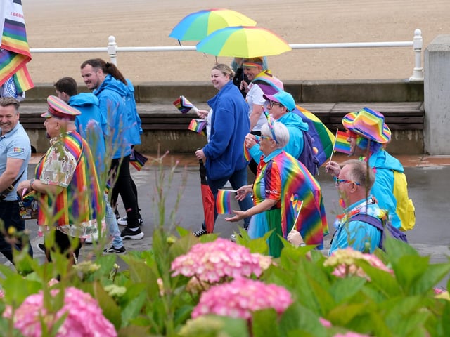 Colourful pride- themed umbrellas were needed by the determined parade, who did not let the weather ruin their celebrations.