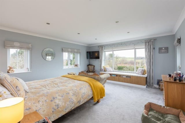This bedroom has a beautiful view over open fields and countryside.