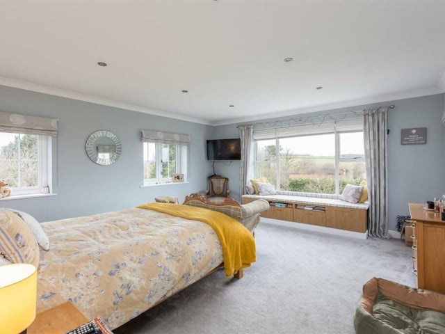 This bedroom has a beautiful view over open fields and countryside.
